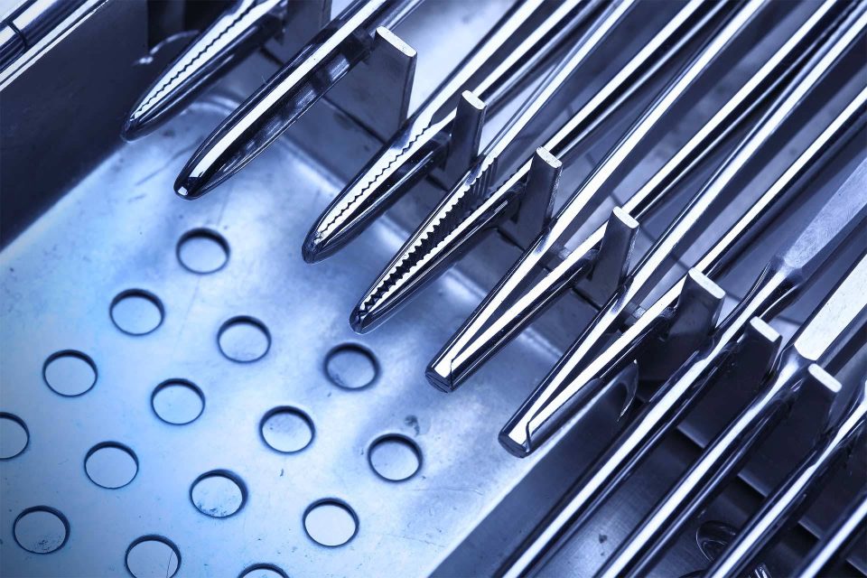 Metal medical tools waiting to be processed through BoneSim's standardized clinical reprocessing cycles.